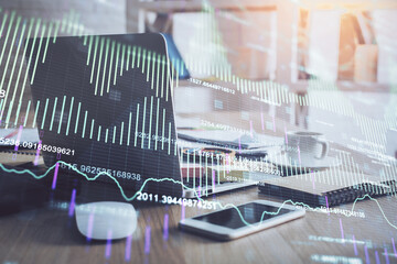 Financial chart drawing and table with computer on background. Double exposure. Concept of international markets.