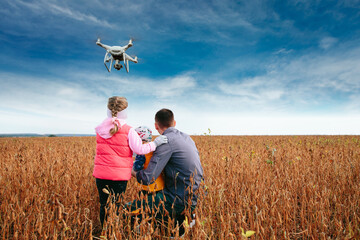 Drone being operated by father and son at the field