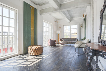 Chic, luxurious guest room design with old-fashioned antique furniture. white walls are decorated with relief. there is a beautiful dark brown parquet on the floor.