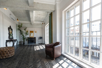 Chic, luxurious guest room design with old-fashioned antique furniture. white walls are decorated with relief. there is a beautiful dark brown parquet on the floor.
