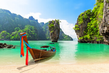 Travel photo of James Bond island with thai traditional wooden longtail boat and beautiful sand beach in Phang Nga bay, Thailand. - obrazy, fototapety, plakaty