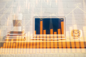 Financial market graph hologram and personal computer on background. Double exposure. Concept of forex.