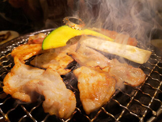 Pork roasted on a hot, smoky charcoal grill.