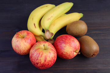 Heap of Fresh Ripe Tasty Fruits on Dark Brown Wooden Background for the Concept of EATING WELL