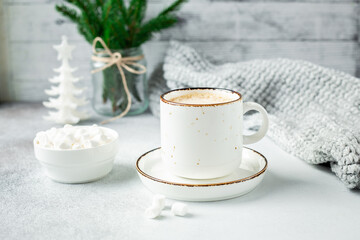 Obraz na płótnie Canvas Cup of coffee, scarf and garland. Cozy Christmas composition. Scandinavian style
