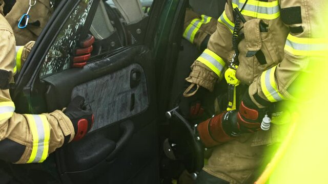 Firefighters cutting car doors to rescue viction of the car crash accident. High quality 4k footage