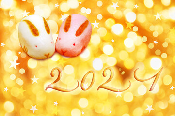 2021 japanese greeting card with rabbit shaped pastries on golden background