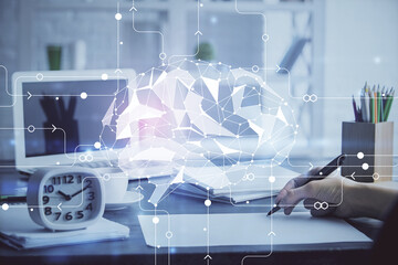 Multi exposure of writing hand on background with brain hologram. Concept of learning.