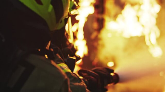 Fireman extinguish fire with the hose. Burning house fire drill. High quality 4k footage
