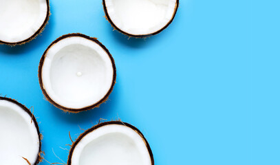 Half coconut on a blue background.
