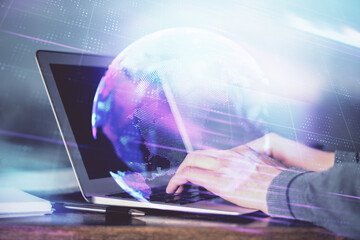 Fototapeta premium Technology theme hologram with man working on computer on background. High tech concept. Double exposure.