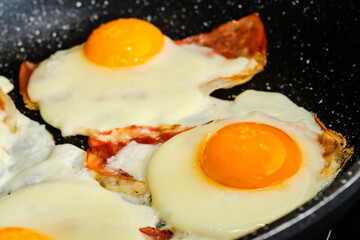 Cooking fried eggs with  bacon