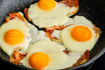 Cooking fried eggs with  bacon