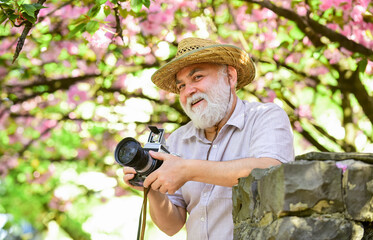 Complete relax. man tourist use camera take photo of cherry blossom. sakura in bloom photography....