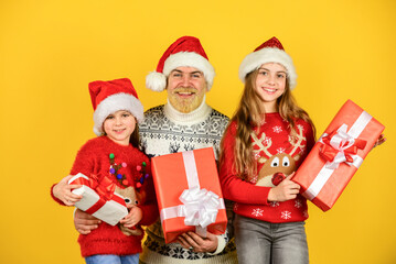Christmas fun. bearded santa man with kids. knitted fashion for winter. new year shopping. time for presents. happy family celebrate xmas. small girls exchange gifts with father. dad love daughters