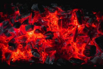 Fototapeta na wymiar hot red coals among black ash, wallpapers for mobile devices, abstract