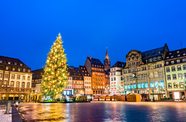 Fototapeta na wymiar Christmas tree at the famous Christmas Market in Strasbourg at night - Alsace, France