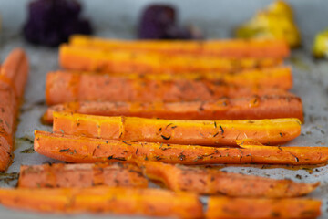 Grilled carrots and cauliflower with aromatic herbs and olive oil.  Mediterranean diet.