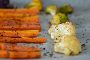 Grilled carrots and cauliflower with aromatic herbs and olive oil.  Mediterranean diet.