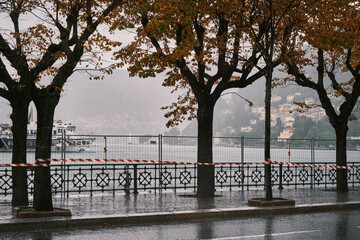 Landscape view of the lakefront of Lake Como in Italy flooding out of its boundaries on a storm day. Lake Como overflowing due to heavy rain