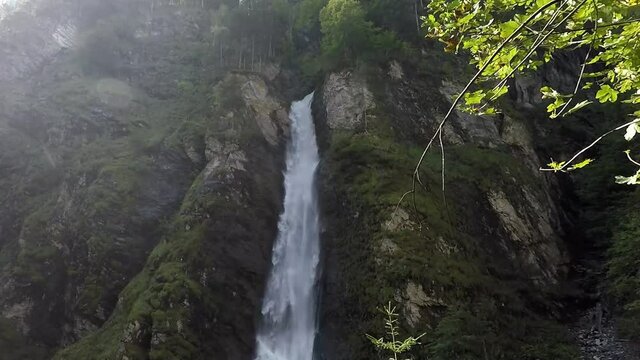 Waterfall with a lot of spray in the sunlight in the Liechtensteinklamm.