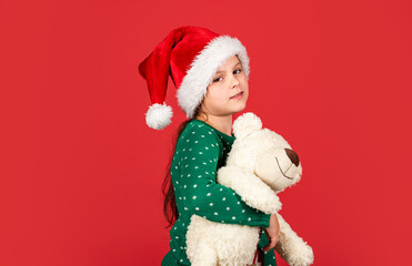 Polar bear. Shopping christmas gifts. Christmas holiday. Winter cheerful season. Xmas shopping sale. Little santa with toy. Small girl santa claus hat red background. Teddy bear. Christmas vibes