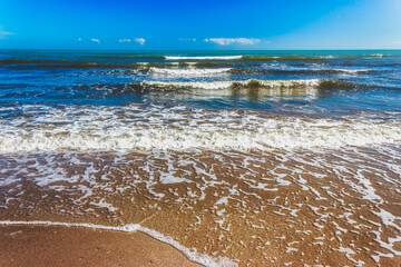Sandy beach of the Adriatic Sea in calm, clear weather. Rimini, Italy
