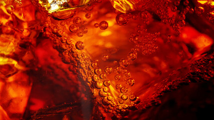 Macro view of Cola with ice and bubbles.