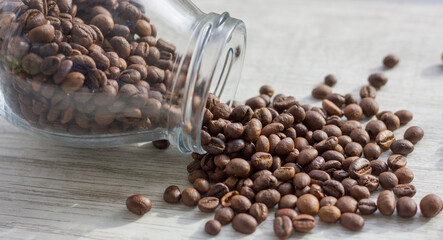 coffee beans are spilled out of the jar. macro