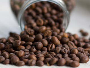 coffee beans are spilled out of the jar. macro