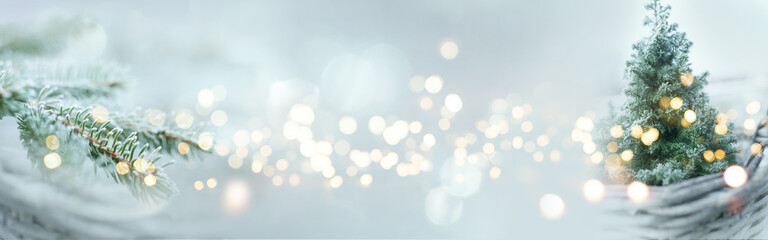 Christmas winter bokeh background. Christmas tree with snow and abstract bokeh lights. Festive...