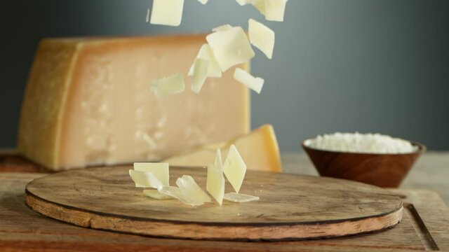 Super Slow Motion Shot of Parmesan Shavings Falling on Wooden Board at 1000 fps.