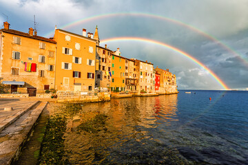 Wonderful morning view of old  Rovinj town with multicolored buildings and yachts moored along...