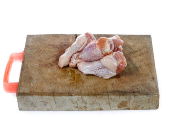raw chicken legs on a white background