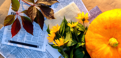 Thanksgiving or Halloween day concept. Composition with pumpkin, yellow flowers and autumn leaves