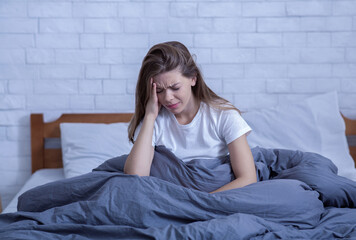 Lonely stressed woman having mental disorder, suffering from depression or migraine, deprived of...