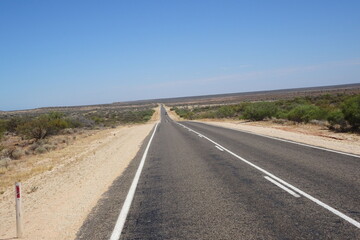 Fototapeta na wymiar Roadtrip on empty straight road in Western Australia