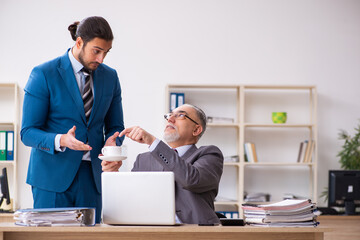 Two male colleagues working in the office