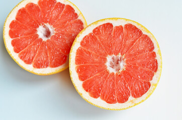 Naklejka na ściany i meble Fresh red grapefruits slices on white background