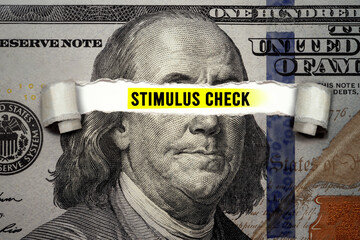 Torn bills revealing Stimulus Check words. Idea for USA check, Coronavirus affects US dollar,...