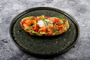 Open sandwich with salted red fish, poached egg, balsamic vinegar and micro-greens.