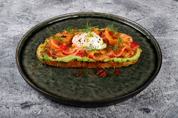 Open sandwich with salted red fish, poached egg, balsamic vinegar and micro-greens.