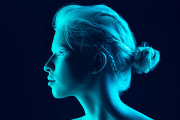 Night. Close up portrait of beautiful albino girl on dark background in neon light. Blonde female model with dreamlike make-up and well-kept skin. Concept of beauty, cosmetics, style, fashion. - obrazy, fototapety, plakaty