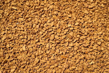 Background of coffee granules at life-size magnification.