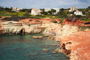 Fototapeta premium Sea Caves, Rocky Coast with a city above