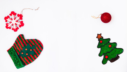 Banner for new year and christmas celebration. Mitten, wooden snowflake,  new year toy, christmas tree. Minimal holidays, winter and celebration concept. Flat lay, top view. Copy space for text.