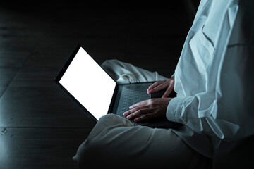 Woman use laptop in dark room.