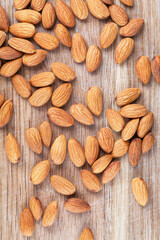 Detail shot of many almonds on a wooden background