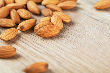 Detail shot of many almonds on a wooden background