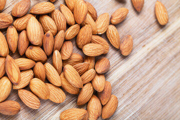 Detail shot of many almonds on a wooden background